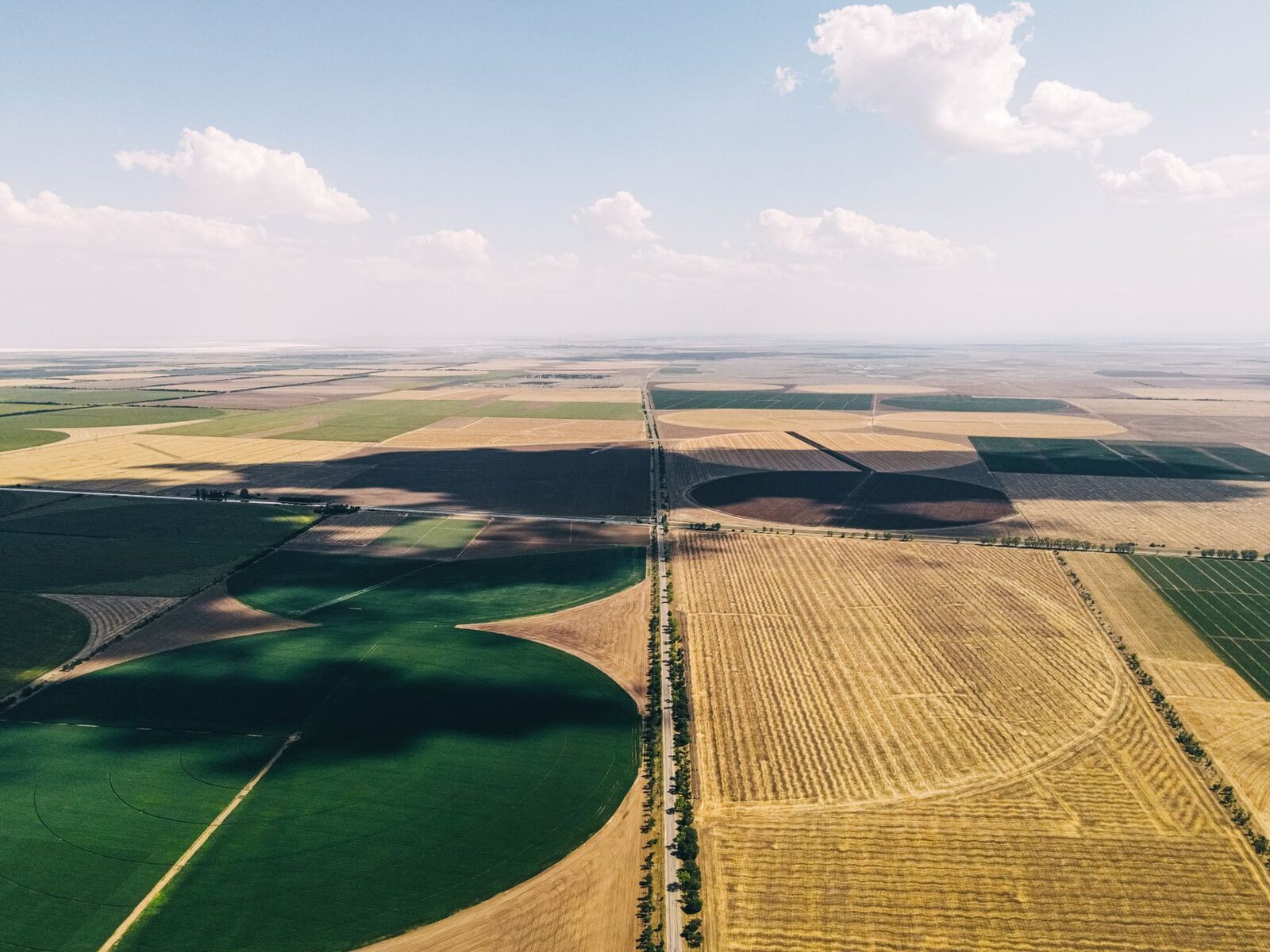Aerial view of patchwork US farmland parcels with a federal government document overlay