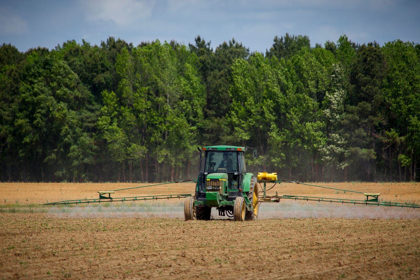 Agricultural field with spray equipment