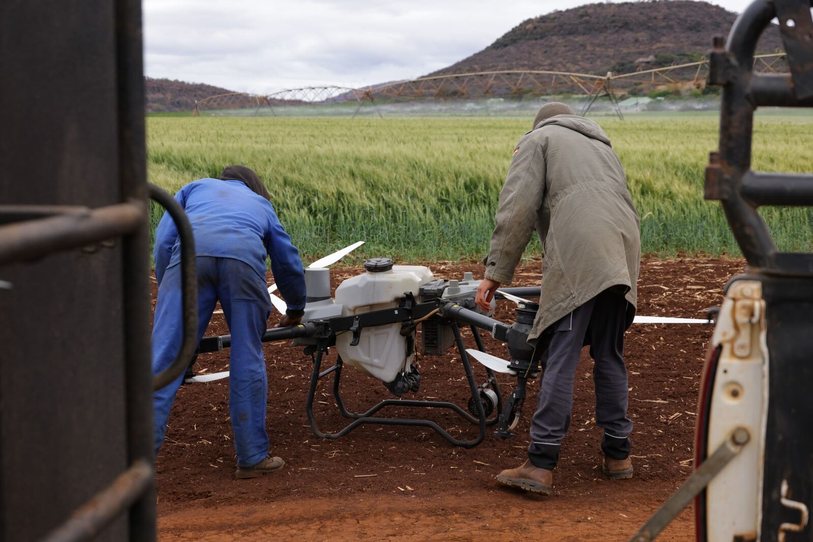 Agricultural drone hovering over farmland during precision spraying operation